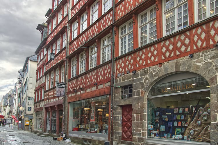 Façades à pans de bois rouges et en pierre dans une rue piétonne du centre ancien de Rennes